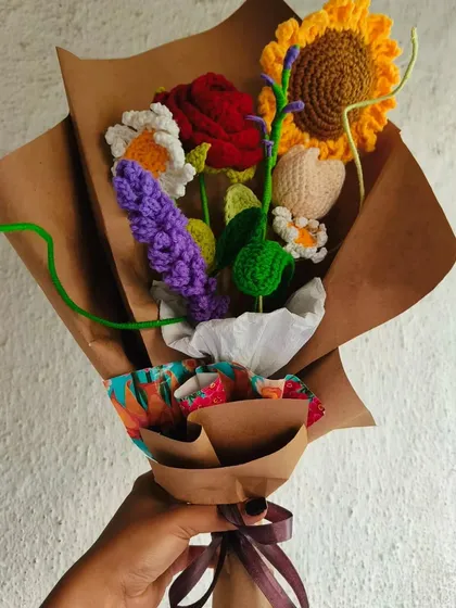 This is one of my proudest creations, a beautiful mixed bouquet with a little bit of everything. It has a bright sunflower, a classic red rose, delicate daisies, and even some lavender, all handmade with yarn and love.