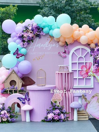 A wider view of Aaradhya's butterfly-themed photo booth, showing the full balloon arch and the arrangement of props, creating a perfect spot for magical photos.