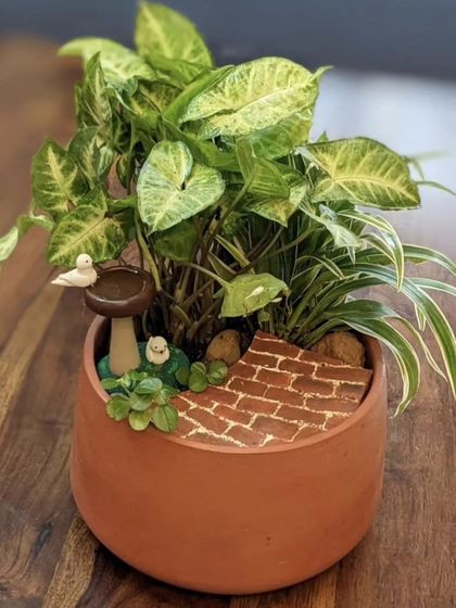 Here is a mini garden arrangement I created using my bird bath miniature. It shows how a single accessory can inspire a whole scene with a brick path and plants.