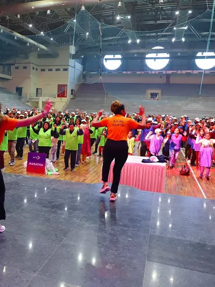 My team and I leading the crowd from the stage at an indoor sports meet. The energy was just as high indoors!