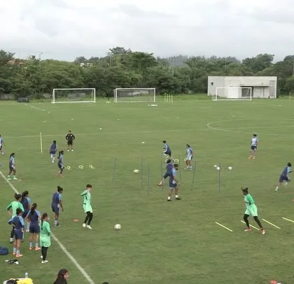 A wide view of a team training session on the pitch. Organizing and conducting drills for a large group requires careful planning to ensure every athlete is engaged and working towards the session's goals, whether it's speed, agility, or endurance.