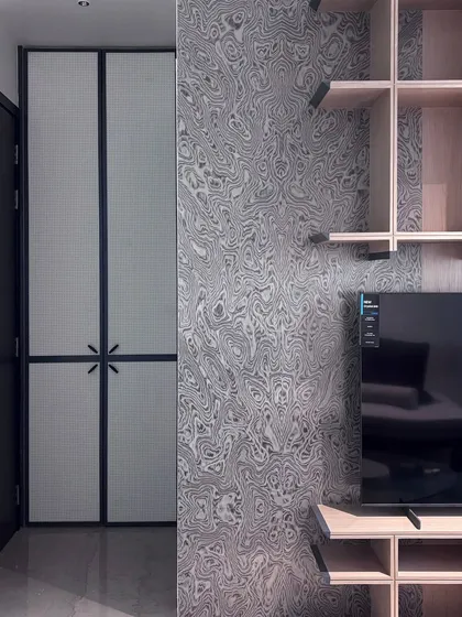A closer look at the unique, swirling pattern of the wallpaper in the multipurpose room, which provides a bold contrast to the clean lines of the wooden shelves.