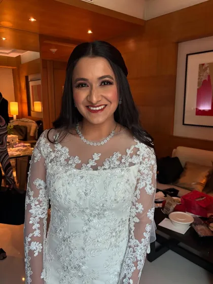 A happy, smiling portrait of the bride Michelle, all set for her Catholic wedding. The makeup is fresh, natural, and glowing.