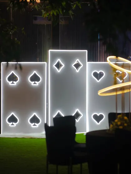 A fun and thematic photo-op for a Diwali card party, featuring large, illuminated panels of playing card suits.