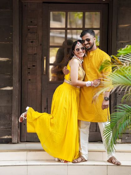 A playful and happy portrait of the couple during their Haldi festivities.