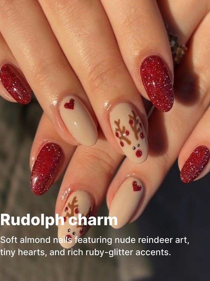 A charming Rudolph-inspired design on soft almond nails, featuring nude reindeer art, tiny hearts, and rich ruby-glitter accents.