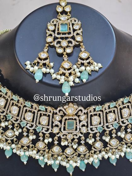 The maang tikka and choker from the mint green set, which is a favorite among modern brides.