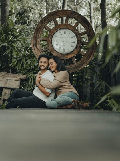 A warm embrace tells a story of comfort and love. This cozy pre-wedding portrait was taken on a wooden deck surrounded by nature.