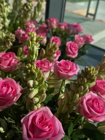 A beautiful shot of fresh pink roses and tuberoses, showcasing the quality and vibrancy of the flowers we use in our arrangements.