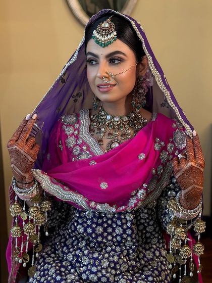 The bride showcasing her full Anand Karaj attire, with her hair perfectly styled.