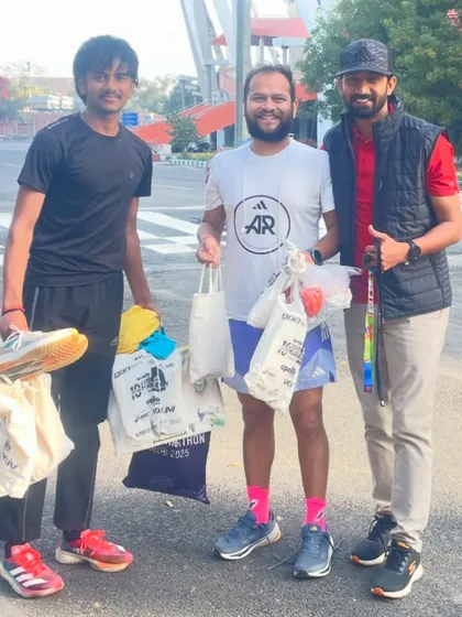 With a fellow coach who helped collect and distribute running gear to young athletes. It takes a community to build champions, and I am grateful for the support.