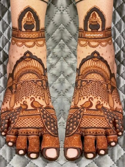 A beautiful and symmetrical foot design featuring peacocks and architectural motifs.
