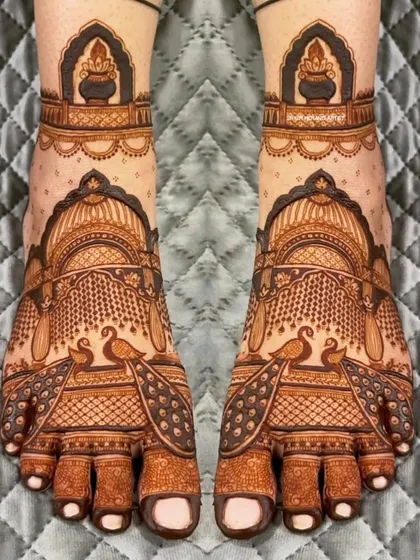 A beautiful and symmetrical foot design featuring peacocks and architectural motifs.