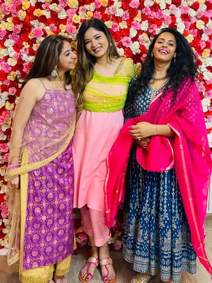 Celebrating with friends at a wedding event. I'm wearing a royal blue Anarkali with a contrasting bright pink dupatta. This shows how to play with bold colors for a stunning festive outfit.