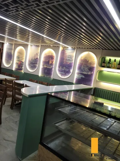 The backlit arched wall panels feature artistic murals, creating a unique and atmospheric backdrop for diners at Rigo Restaurant.