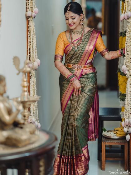 Akanksha is a radiant vision for her engagement ceremony. She wears a beautiful olive green and pink Kanchivaram, which I paired with a custom hand-embroidered blouse in a contrasting yellow.