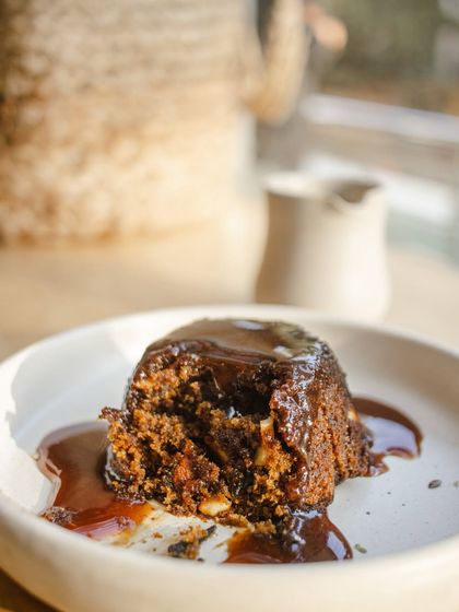 A close-up of our Sticky Toffee Pudding, showing its moist texture and rich toffee sauce.