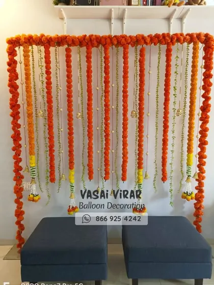 Here is a classic and vibrant backdrop we designed, perfect for a Haldi ceremony or a naming ceremony. We used strings of fresh orange marigold flowers to create a simple yet beautiful photo corner, bringing a touch of tradition to the event.