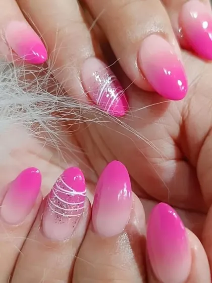 A closer look at the pink ombre set, highlighting the intricate web-like line art on the accent nail.