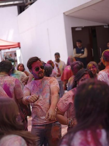 The crowd dances together at our indoor Holi celebration. I can adapt the festival experience for any venue, ensuring the vibe is right, rain or shine.
