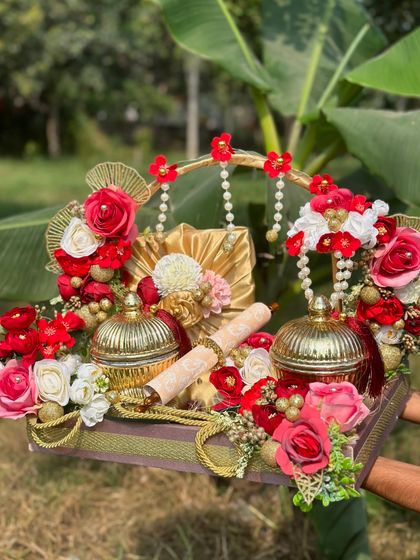Another take on a grand first invitation platter. This one uses a vibrant red and gold theme, with decorative jars, a scroll, and pearl hangings to create a truly royal announcement.