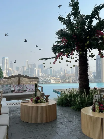 The overall ambiance of the rooftop venue, with our custom decor, seating, and the stunning view of the city and pool.