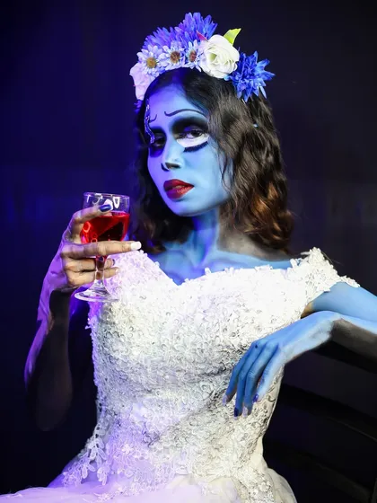 A seated portrait of the Corpse Bride, holding a glass of "wine." This shows how to use props and posing to enhance the character's story.