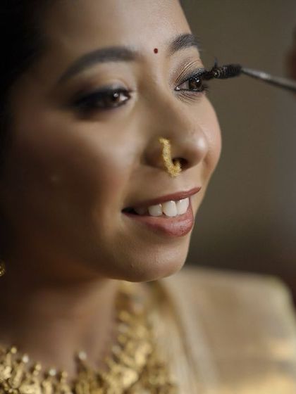 A behind-the-scenes moment of applying lashes. This is a crucial step for adding definition and glamour to the eyes, and I use high-quality, comfortable lashes.