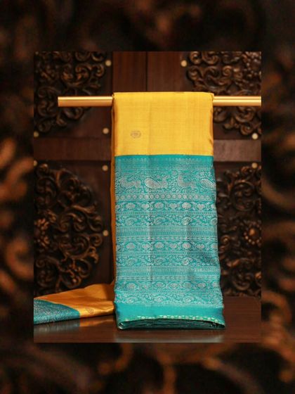 A yellow Kanjivaram with a stunning blue brocade border, a classic choice for Day 1 of Navratri.