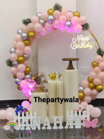 A lovely ring decoration with pastel pink, gold, and silver balloons. The setup is perfect for a small, intimate home celebration.