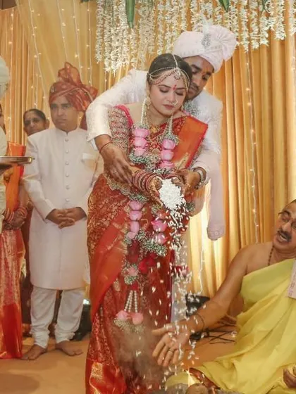 A candid moment from a South Indian wedding ritual, capturing the joy and tradition of the ceremony.