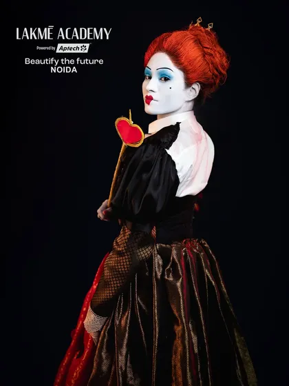 A portrait of the Queen of Hearts. The white-out face, heart-shaped lips, and bright red hair are iconic elements that our students learn to recreate with precision.