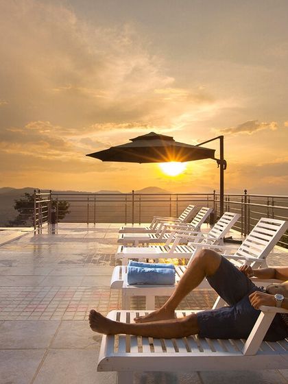 Soaking in the sunset from the infinity pool at Coorg Cliffs Resort. This is the kind of luxurious relaxation I can arrange for you, with panoramic views of the Western Ghats.