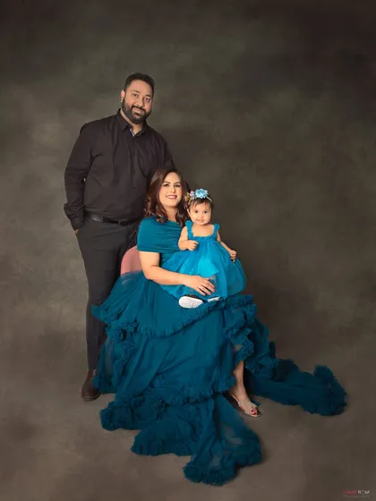 A formal family portrait that feels like a fairytale. The coordinating outfits and the elegant backdrop make this a truly stunning keepsake for this family.