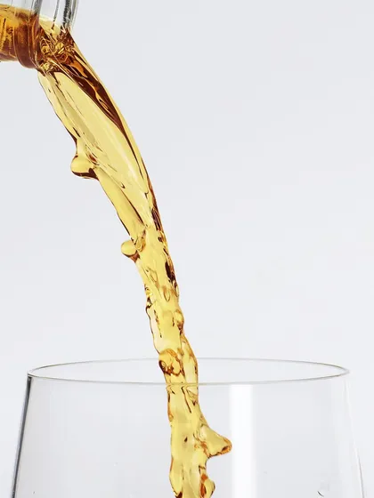 A personal experiment in capturing liquids. This is an extreme close-up of a whiskey pour, focusing on the unpredictable, beautiful shapes the liquid creates as it flows. Pure, simple, and mesmerizing.