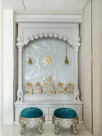 A closer look at the 'Urban Oasis' mandir. The detailed marble carving and the geometric pattern on the back wall create a space that is both traditional and contemporary.