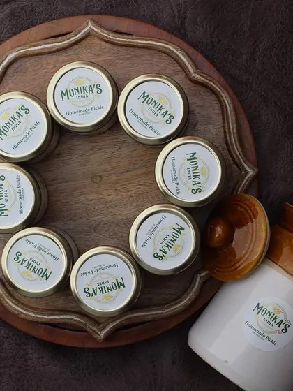 Each jar I prepare is a piece of my family's heritage. This collection, laid out on a traditional wooden platter next to a classic ceramic pickle barni, shows the care and love I put into my work. From my kitchen to yours, this is authentic, homemade goodness.