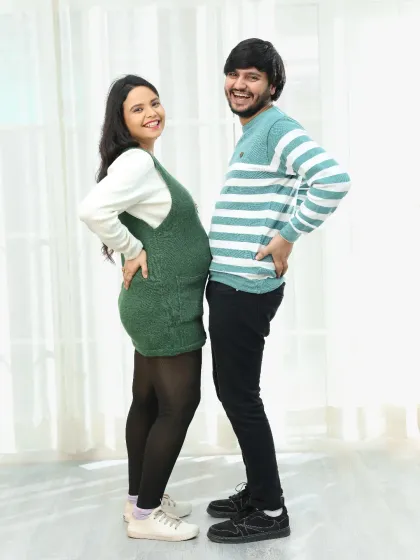 A playful back-to-back "bump off" is a fun pose for couples who want their session to be lighthearted and full of laughter.