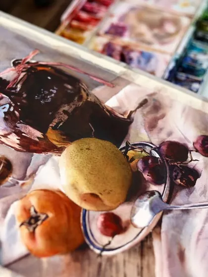 An angled view of a still life demonstration, showing the reflections on the glass and the rich, dark tones of the jug.