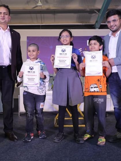 Young winners of our coding and robotics competition proudly stand with their certificates and instructors. We provide opportunities for kids to shine in tech events and build a foundation for a future in innovation.