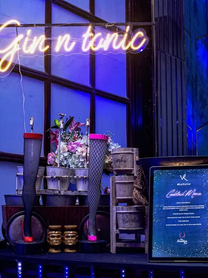 A stylish 'Gin n tonic' bar setup with a modern, minimalist feel. The design incorporates quirky decor like leg-shaped glasses and tiki-style mugs, showing the range of themes I can cater to.