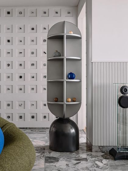 Another angle of the living room's totem shelf, set against the backdrop of the Morse code wall.