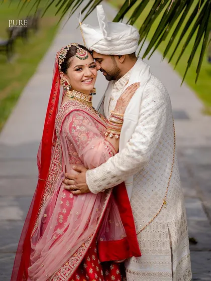 An intimate embrace captured in a beautiful outdoor setting. The couple's happiness radiates from this lovely portrait.