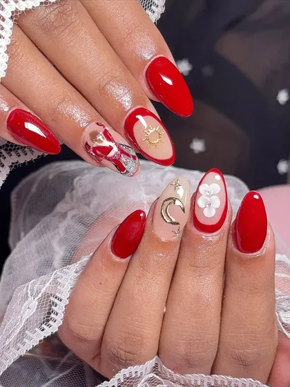 Beautiful Karwa Chauth nails. This festive red set includes a hand-painted depiction of the traditional Karwa Chauth scene, along with moon and star charms.