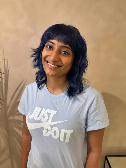 Just look at that smile. A fresh wolf cut and sapphire strands make for one happy client and a seriously cool hair transformation. (No filter)