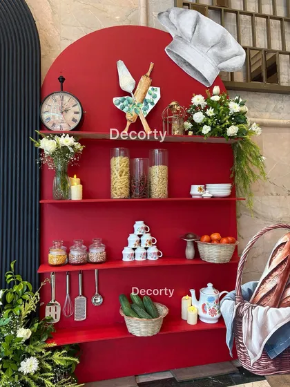 Here is a closer look at the detailed prop styling for the Masterchef theme. I use a mix of real ingredients like pasta and cucumbers with decorative items like a vintage clock and stacked teacups to create a rich, visually interesting display.