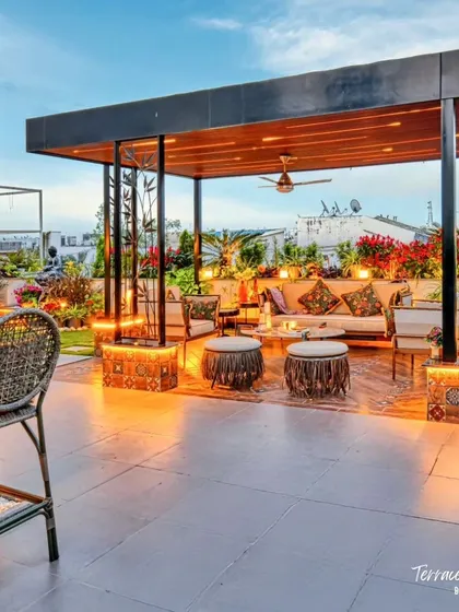 Your terrace can be the most beautiful room of your house. We designed this rooftop garden as a complete outdoor living area, with a stylish bar, comfortable lounge seating under a lit pergola, and lush floral beds that come alive at night.