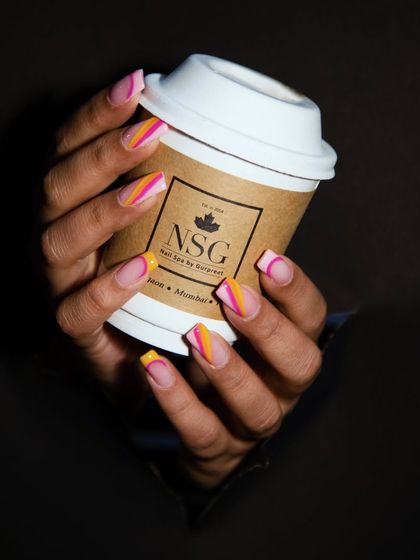 A good day starts with coffee and great nails. This shot captures two of my favorite things: a happy client with beautiful, colorful nails and a cup of coffee from our local partner.