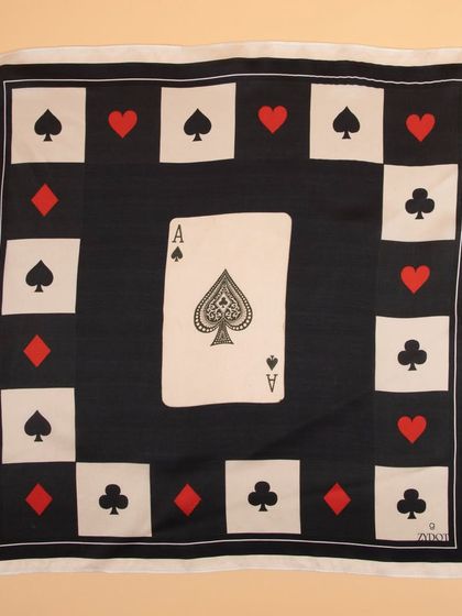 A crisp, flat-lay photograph of a silk pocket square with an ace of spades design, perfect for e-commerce listings.