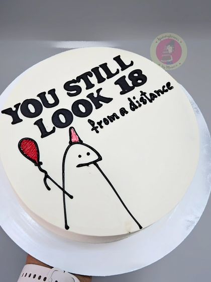 A witty doodle cake that reads, "You still look 18 from a distance."